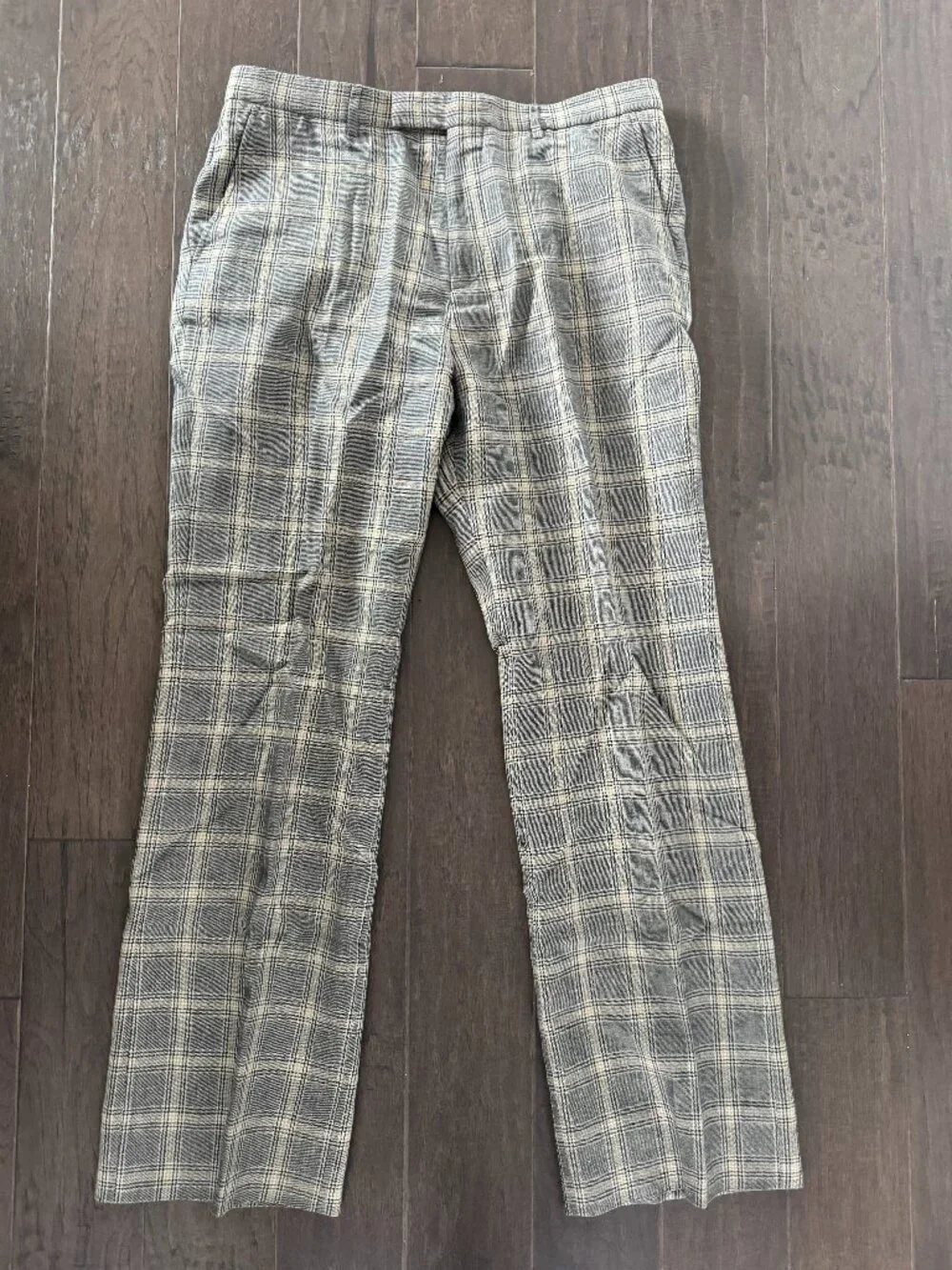 Gucci tartan pants featuring a classic check pattern in gray and beige.